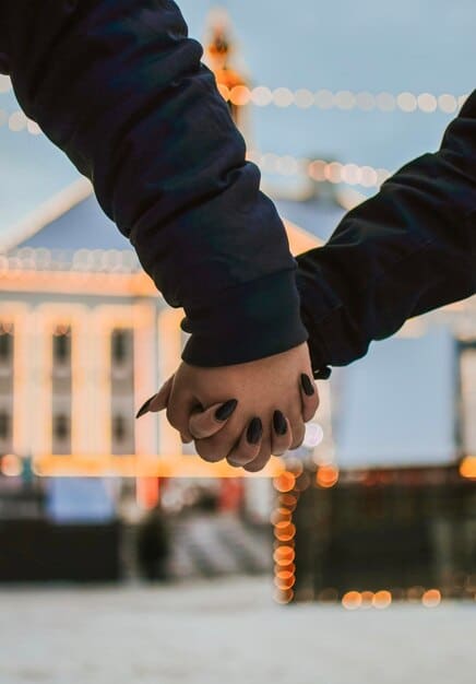 A photo of a same-sex couple holding hands, standing in front of a government building where same-sex marriage is legal, representing the importance of legal recognition.
